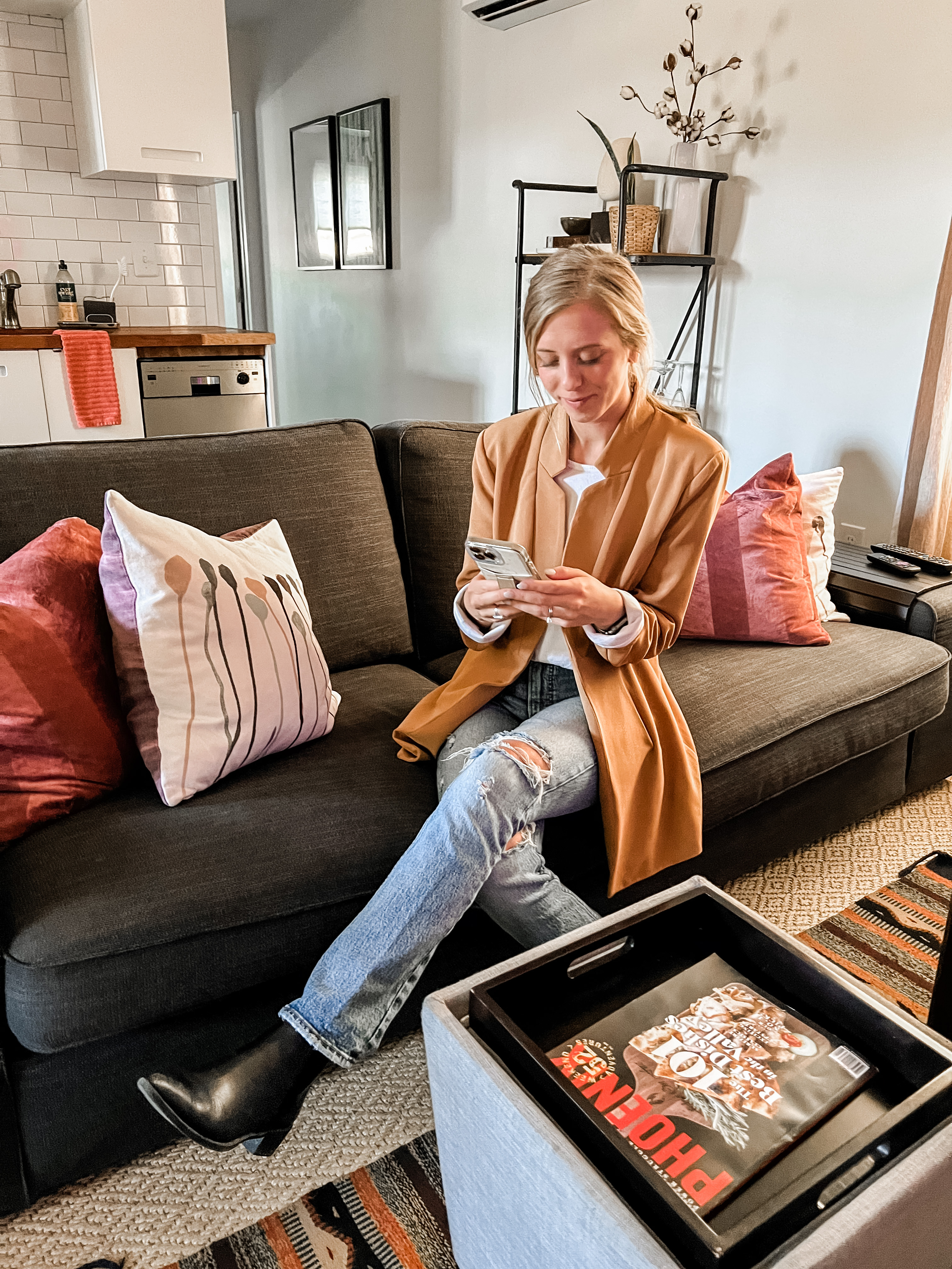 chloe sitting on couch with phone in hand