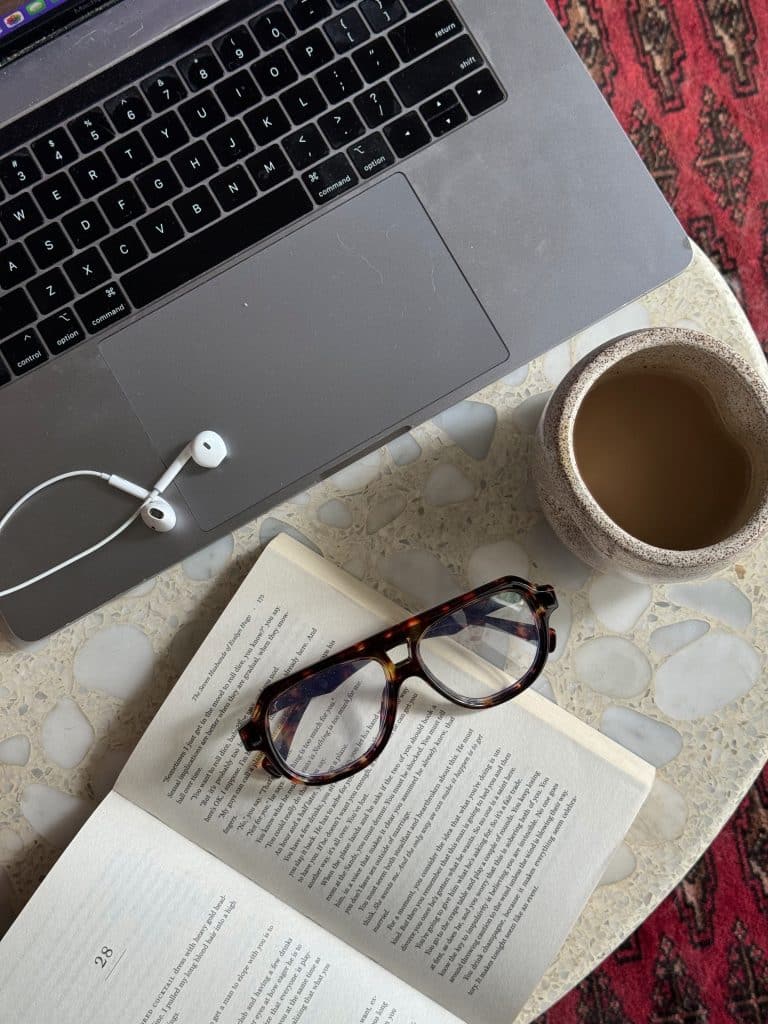 glasses and coffee with a laptop on table