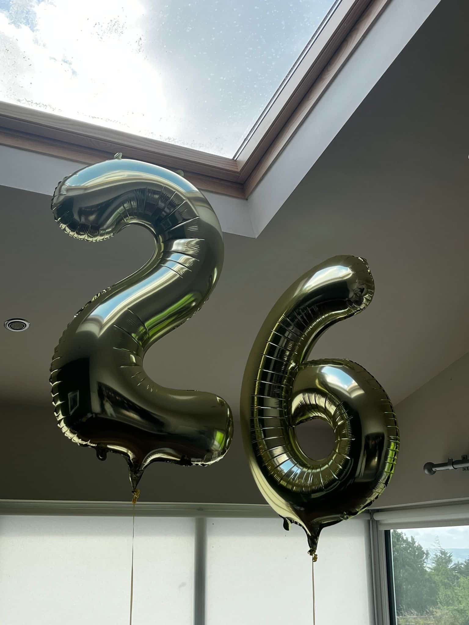 26 balloons floating in the air