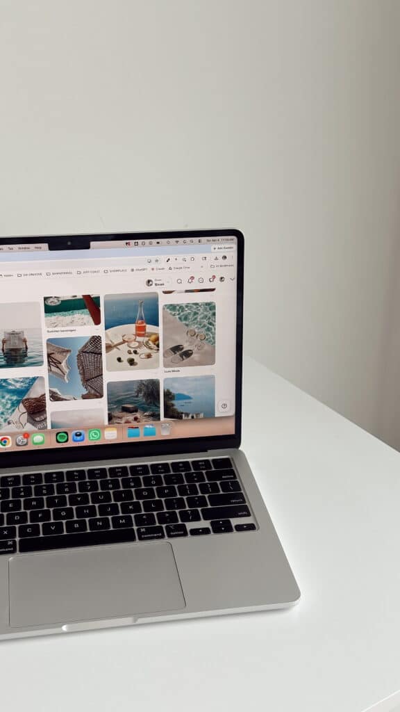 Sleek laptop on white table showing Pinterest-style board for SEO for therapists, including sunny beach photos
