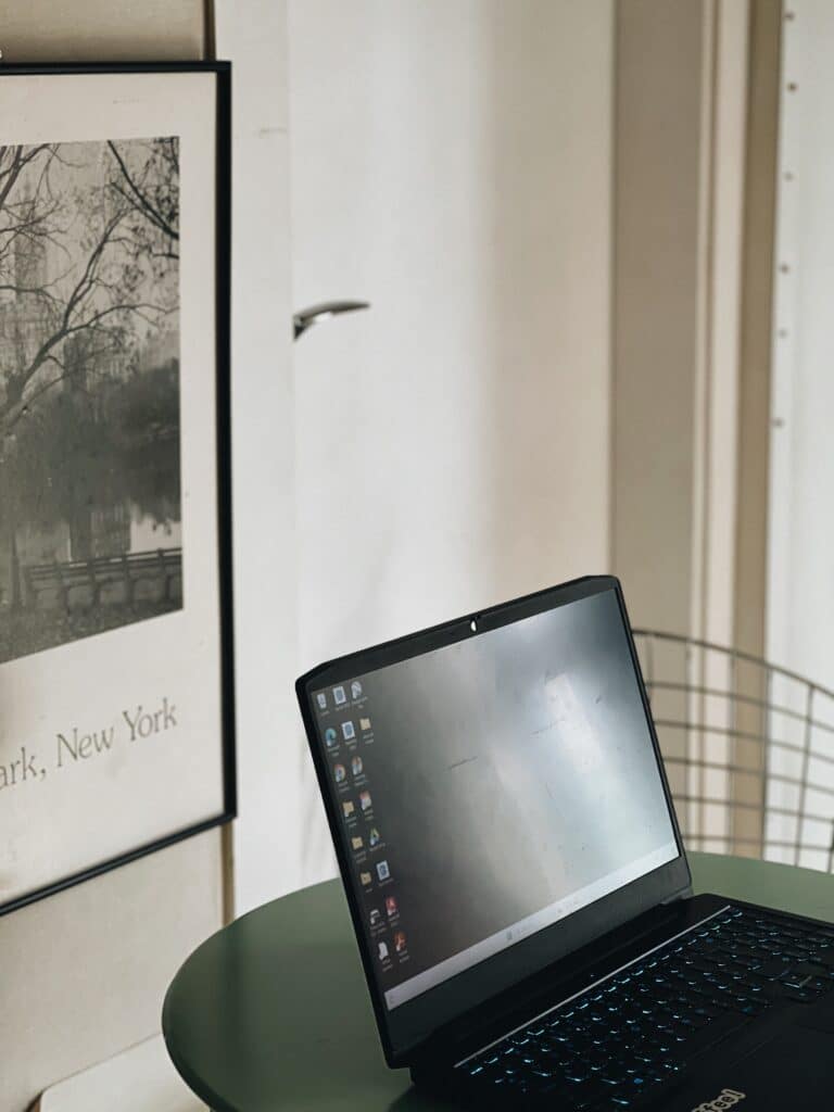 Laptop computer on a dining table beside framed wall art, related to how does seo work.