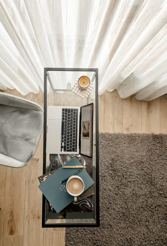 Overhead desk setup with a laptop, tablet, chair, and coffee, ready for how to write seo friendly blogs.
